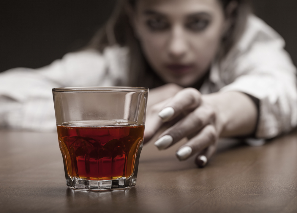 reaching for a drink Stages of addiction denial