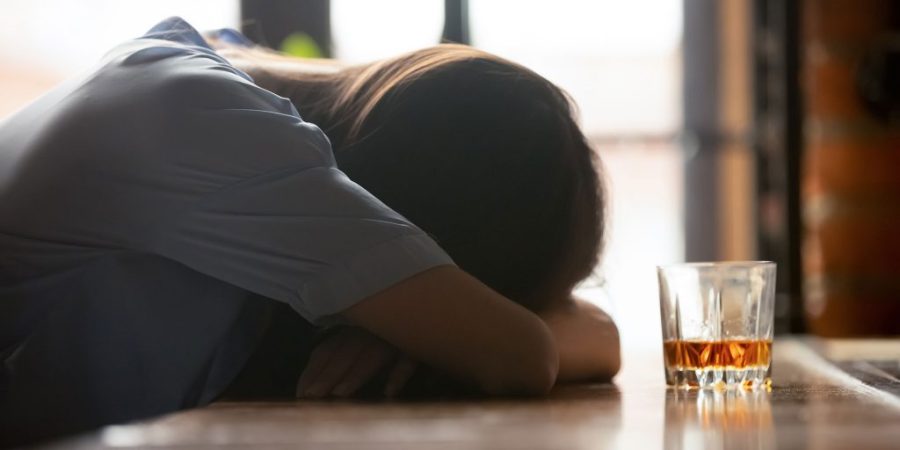 Woman at bar with signs of alcohol poisoning