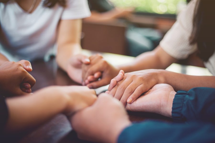 Support group for overdose holing hands on international overdose awareness day